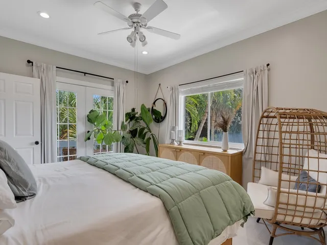 a bedroom with a large bed and a window