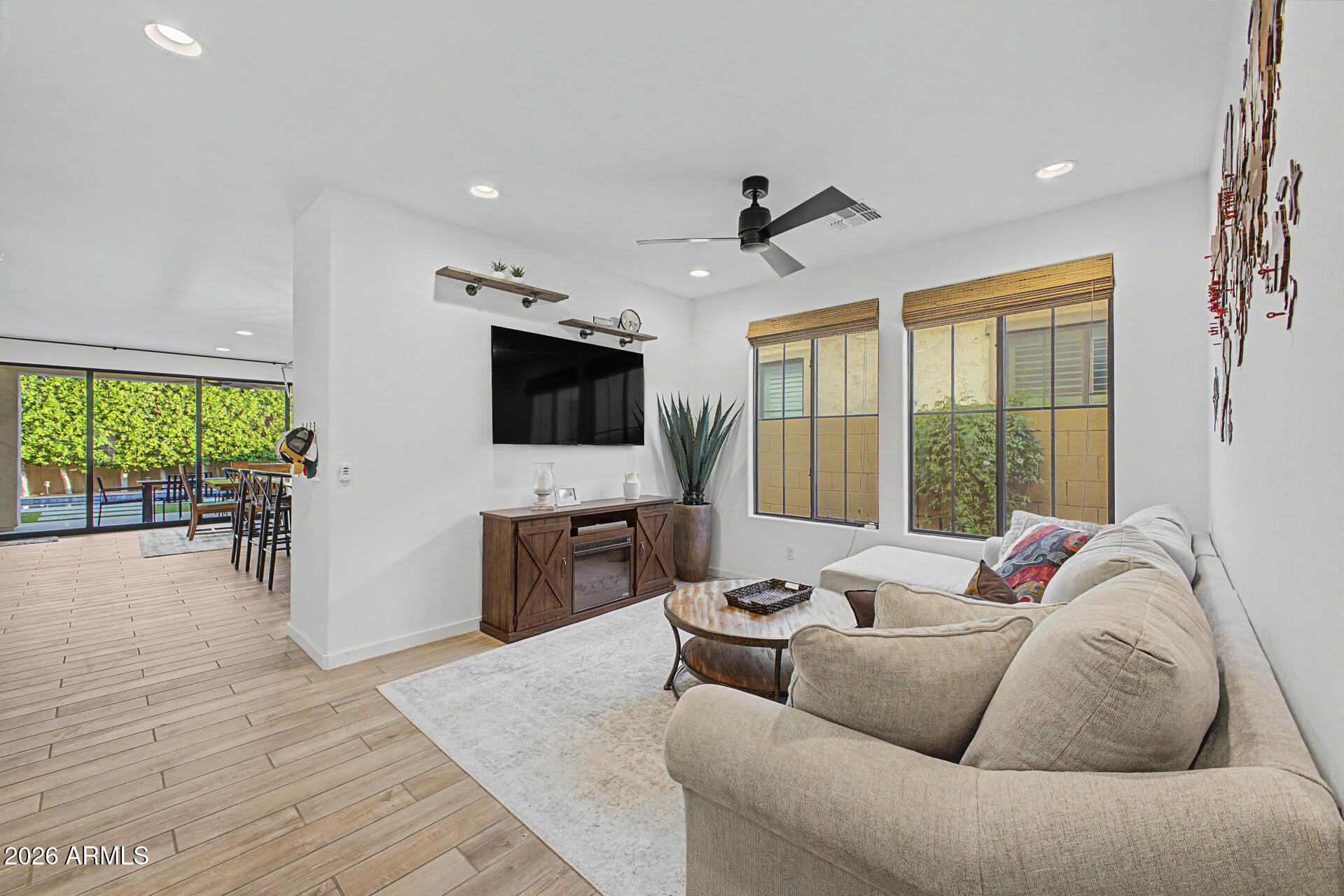 819 West Deer Creek Road Phoenix, AZ 85048 - Photo 14 of 76 a living room with furniture and a flat screen tv
