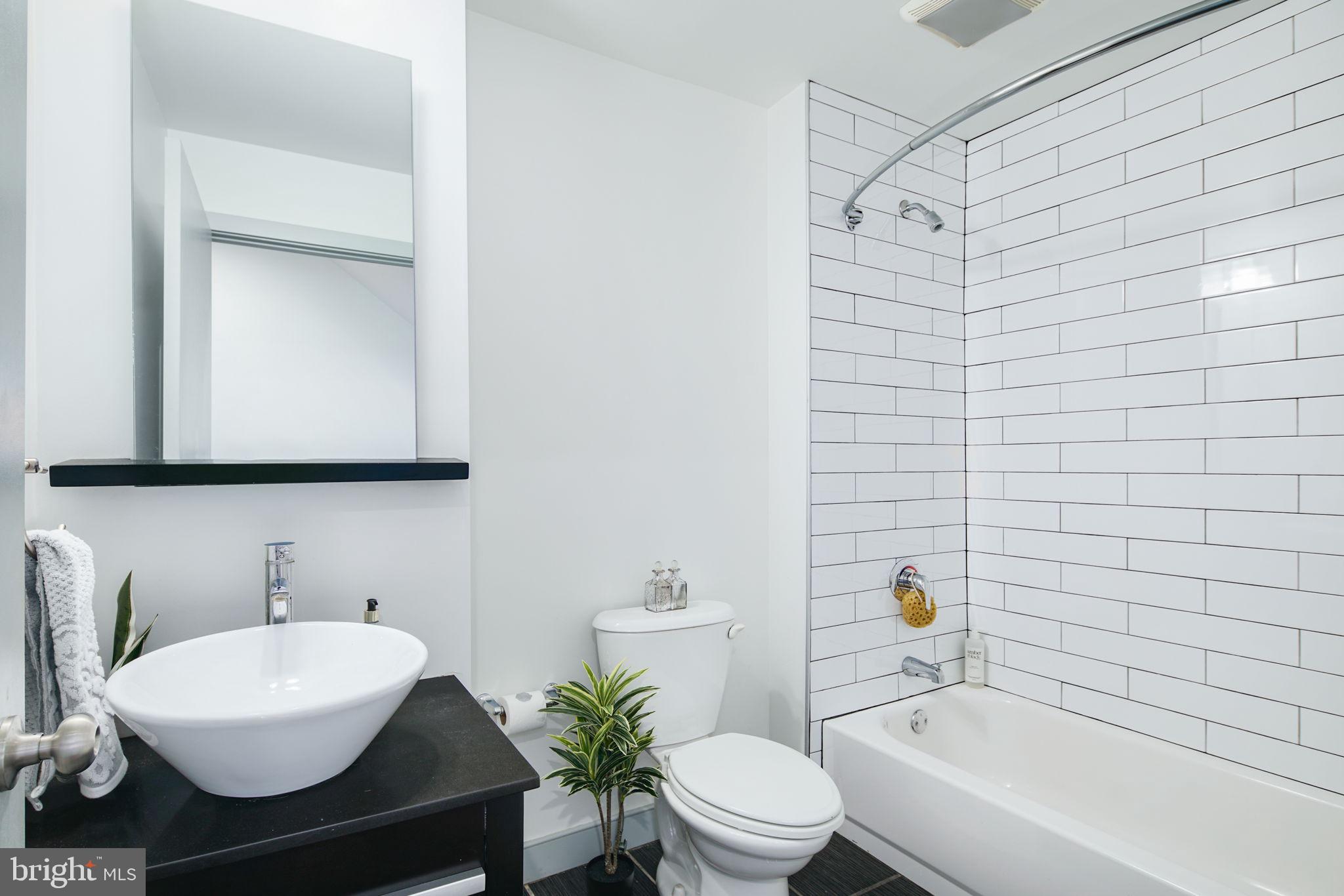 1235 North Taney Street Philadelphia, PA 19121 - Photo 13 of 28 a bathroom with a sink and a mirror