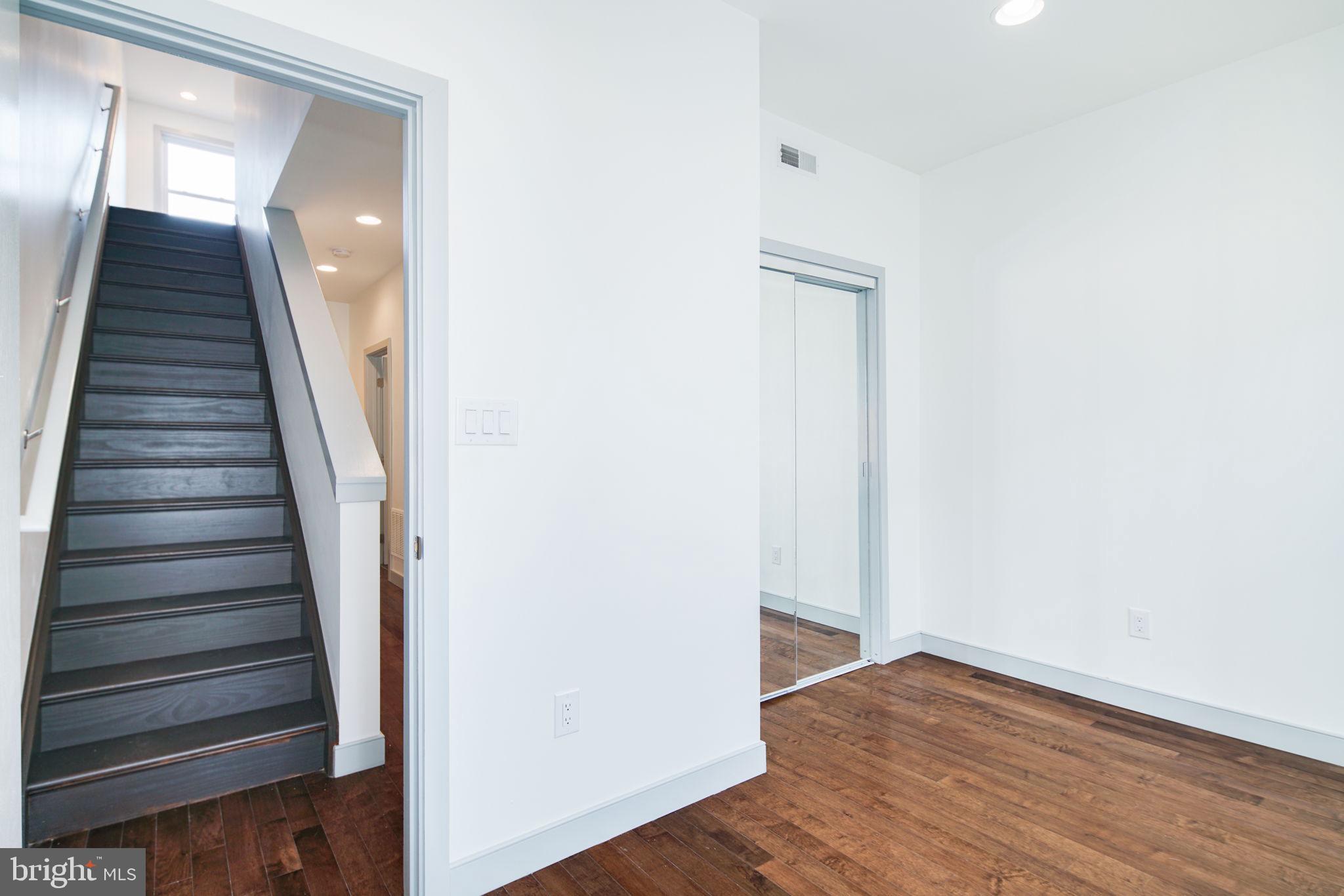 1235 North Taney Street Philadelphia, PA 19121 - Photo 16 of 28 a view of a hallway with wooden floor