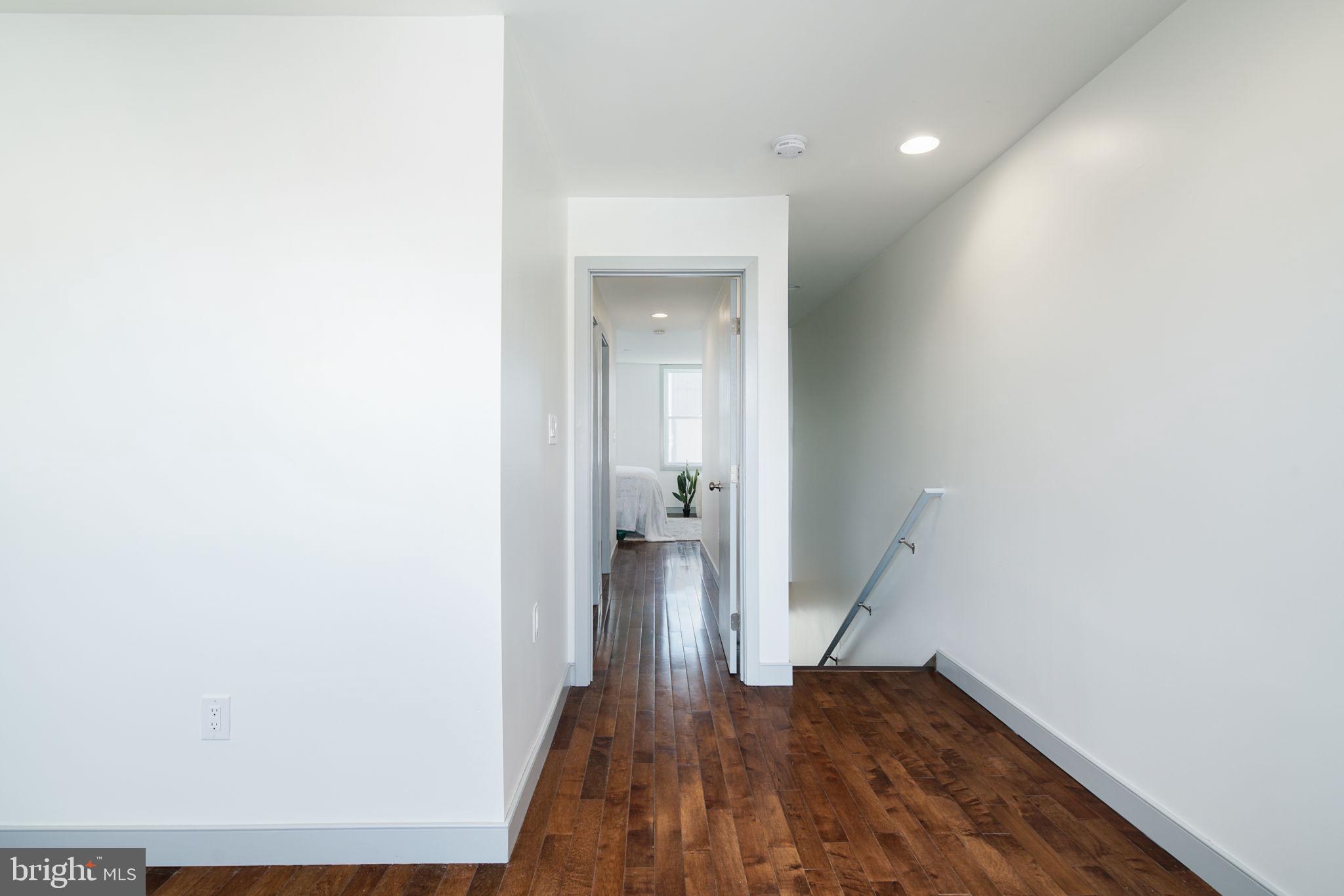 1235 North Taney Street Philadelphia, PA 19121 - Photo 17 of 28 a view of a hallway with wooden floor