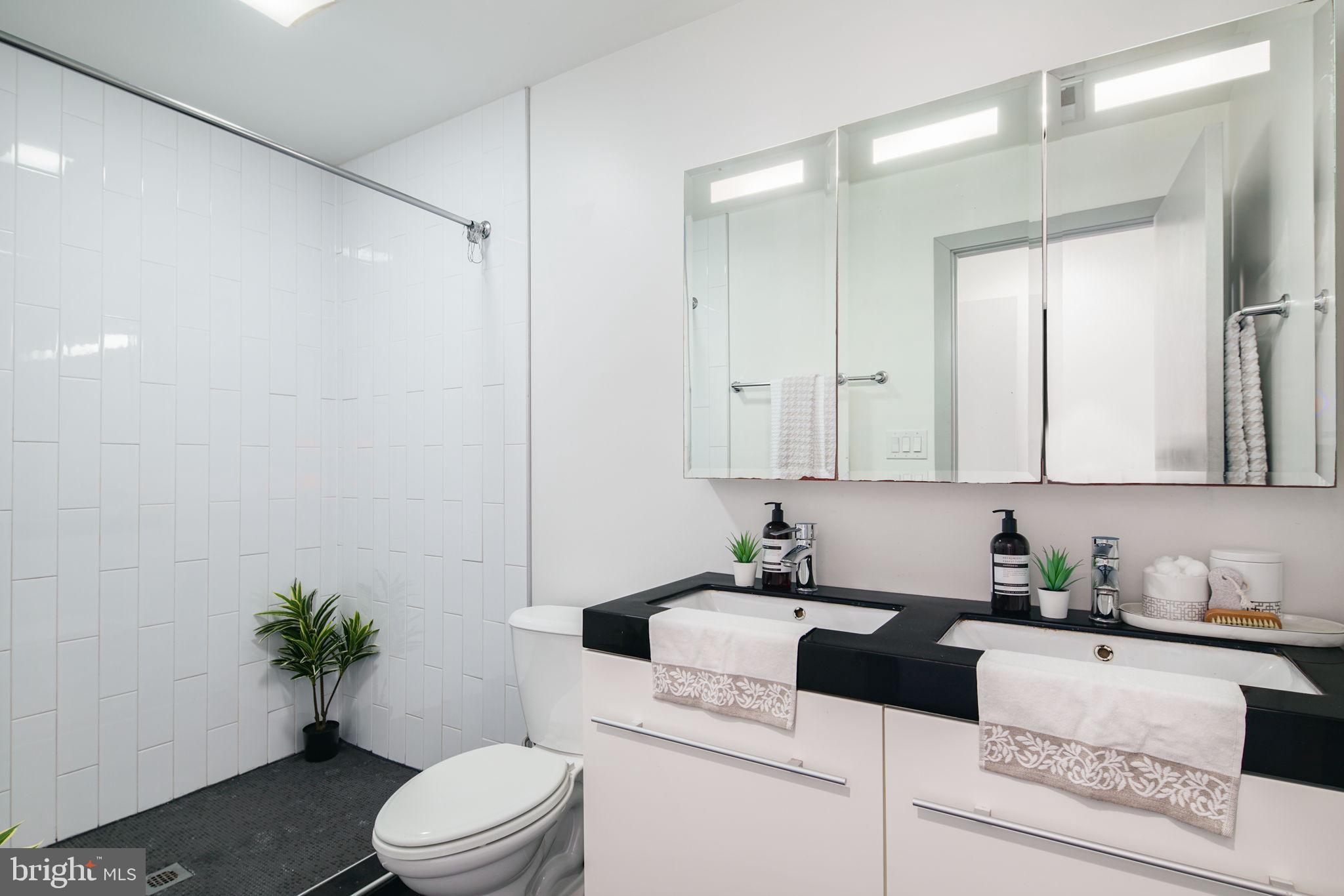 1235 North Taney Street Philadelphia, PA 19121 - Photo 20 of 28 a white kitchen with a sink a toilet and shower