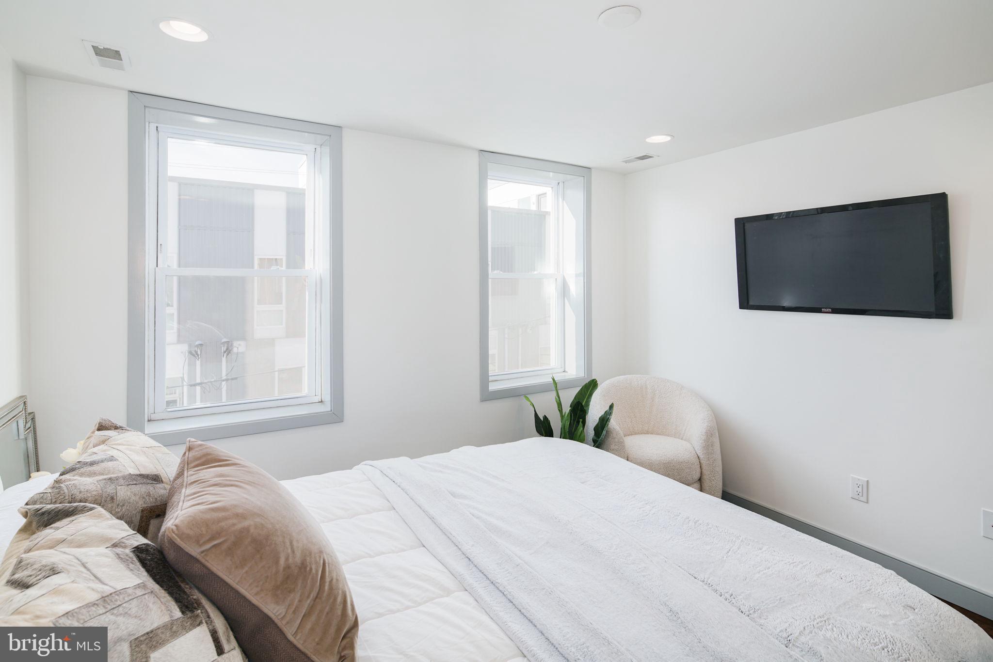 1235 North Taney Street Philadelphia, PA 19121 - Photo 23 of 28 a bedroom with a bed and a flat screen tv