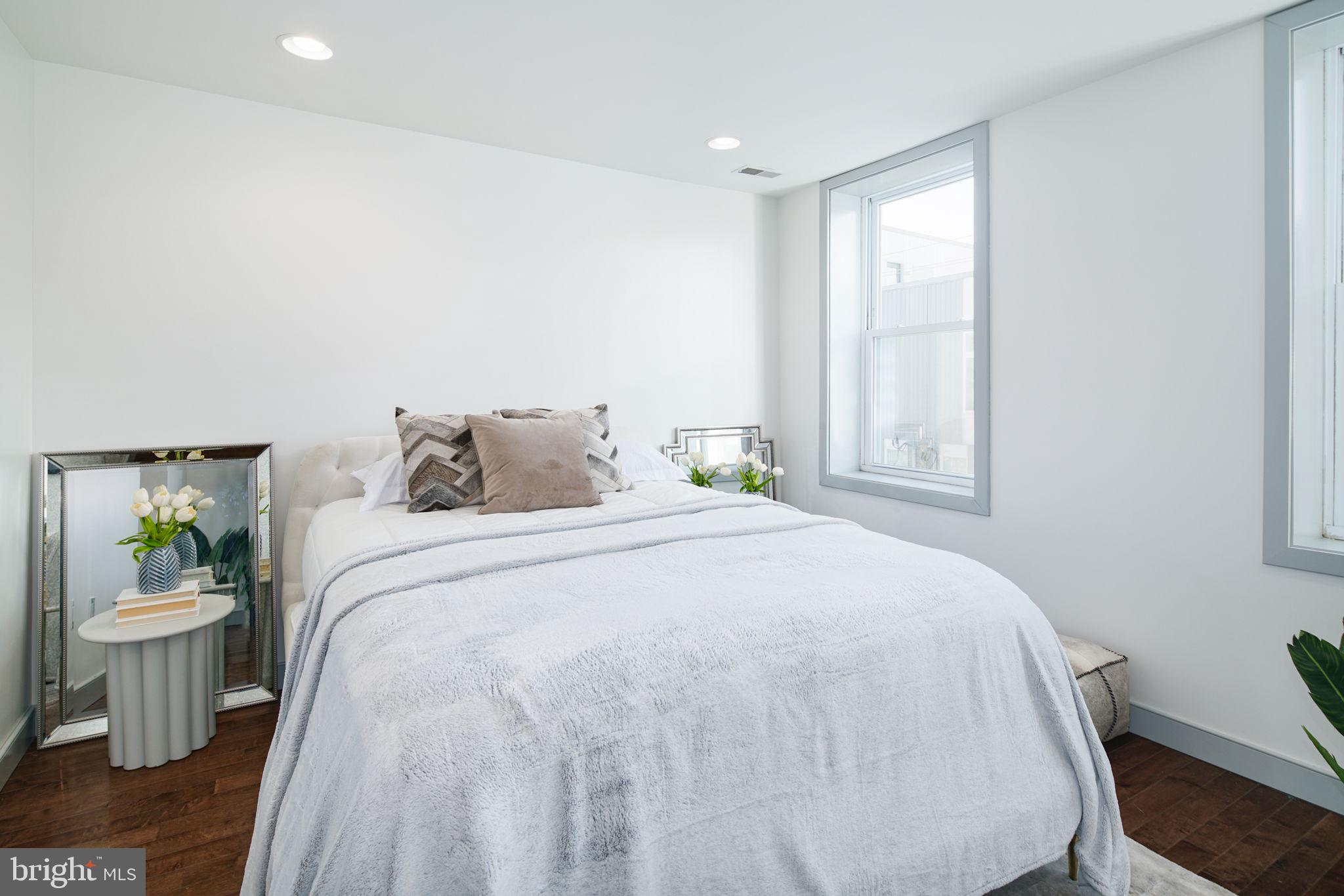 1235 North Taney Street Philadelphia, PA 19121 - Photo 24 of 28 a bedroom with a bed and table