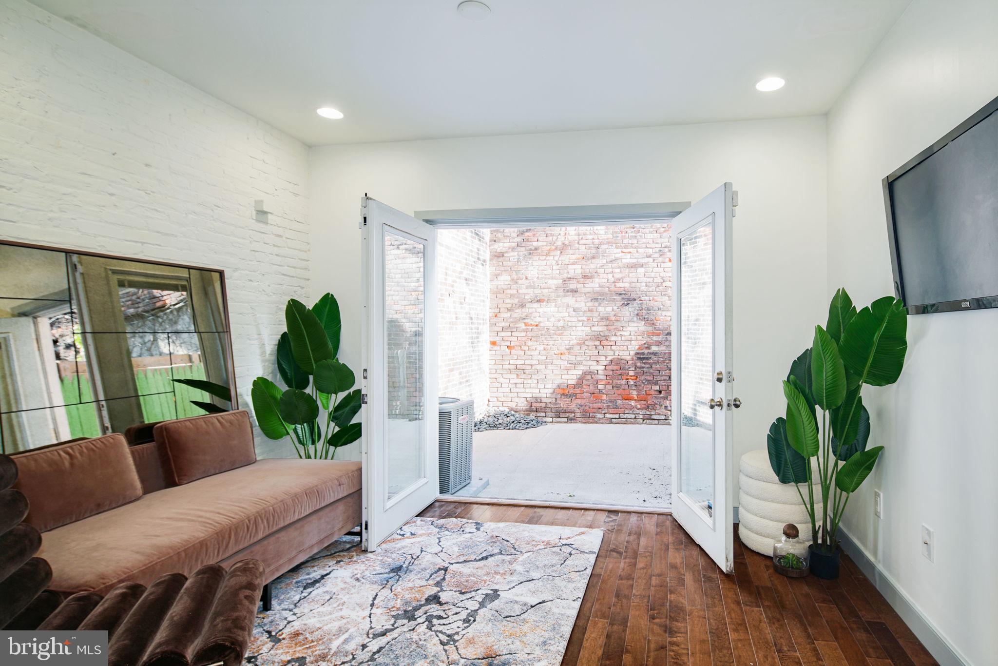 1235 North Taney Street Philadelphia, PA 19121 - Photo 8 of 28 a living room with furniture and a potted plant
