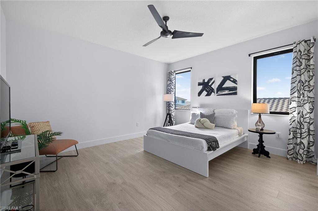 5104 Isidora Lane Ave Maria, FL 34142 - Photo 13 of 28 a bedroom with a bed and a chair in it