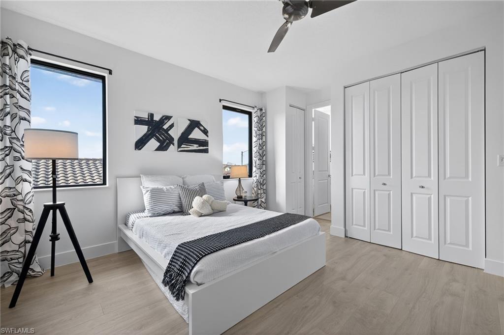5104 Isidora Lane Ave Maria, FL 34142 - Photo 14 of 28 a bedroom with a bed and a chandelier
