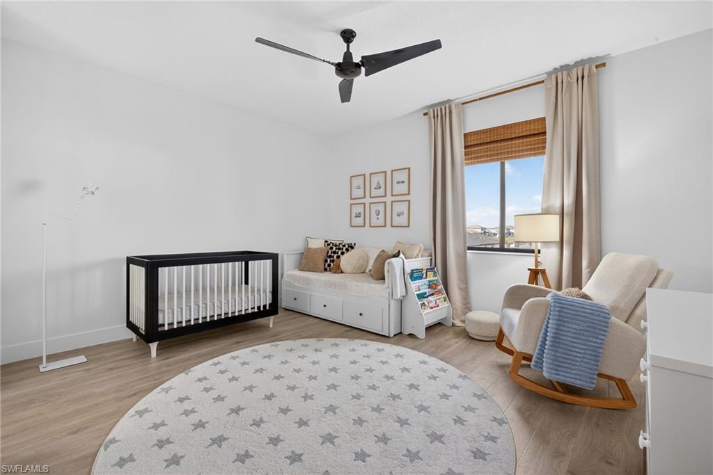 5104 Isidora Lane Ave Maria, FL 34142 - Photo 17 of 28 a bedroom with furniture and a window