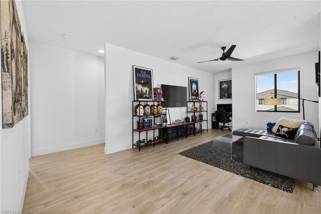 5104 Isidora Lane Ave Maria, FL 34142 - Photo 19 of 28 a living room with furniture and a flat screen tv