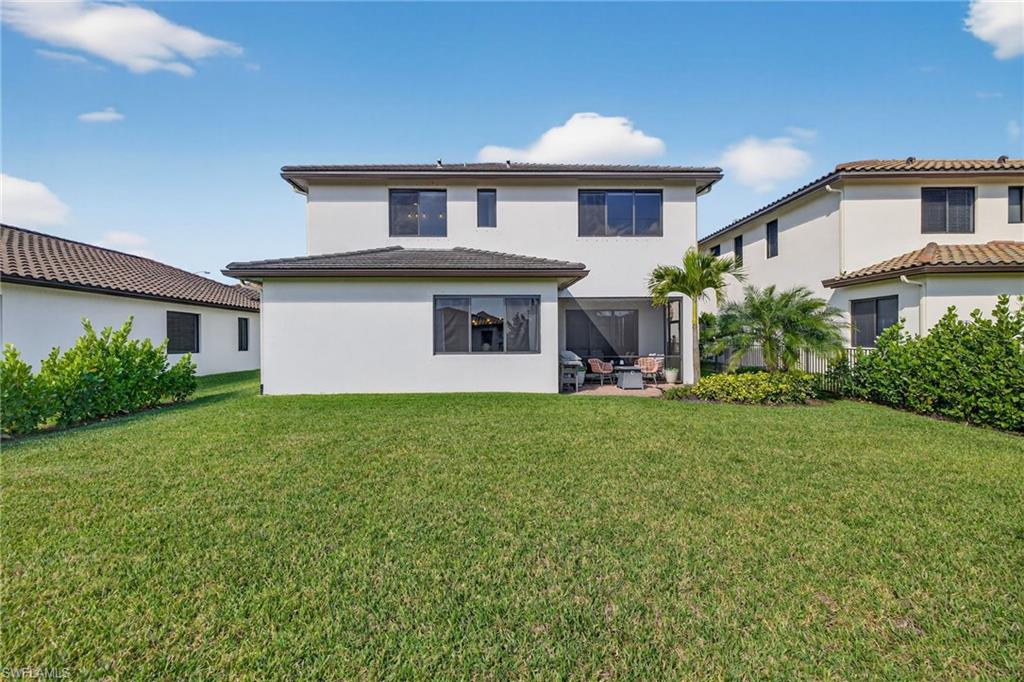 5104 Isidora Lane Ave Maria, FL 34142 - Photo 24 of 28 a front view of a house with a yard