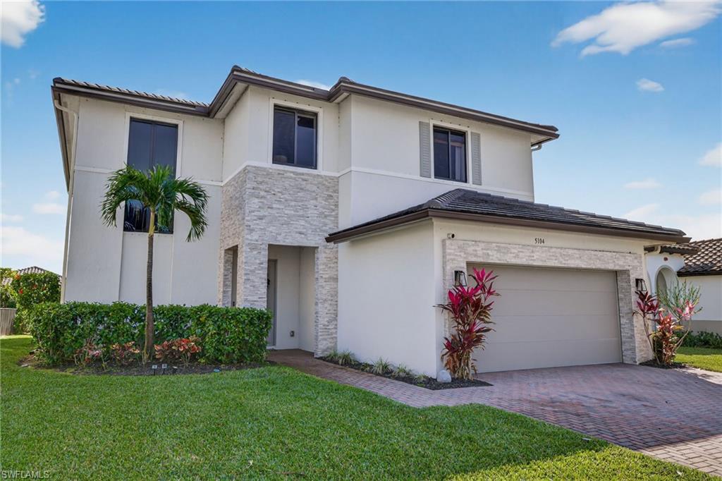 5104 Isidora Lane Ave Maria, FL 34142 - Photo 25 of 28 a front view of a house with a yard and garage