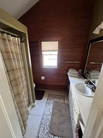 a bathroom with a sink a toilet and a shower