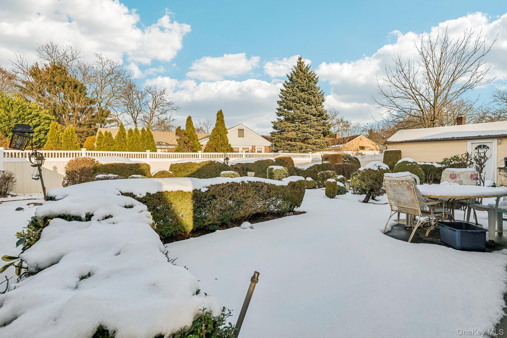 189 Surrey Commons Lynbrook, NY 11563 - Photo 3 of 14 Fenced backyard featuring outdoor dining space