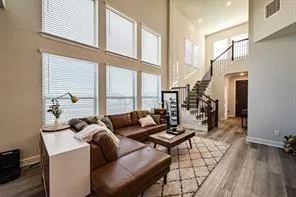 a living room with furniture and floor to ceiling windows