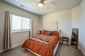 a bathroom with a sink a toilet and shower curtain