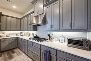 a large kitchen with a table and chairs
