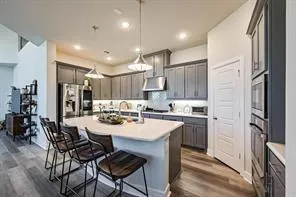 a large kitchen with a table and chairs