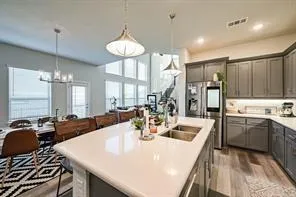 a kitchen with a table chairs stove and cabinets