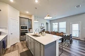 a large kitchen with a table and chairs