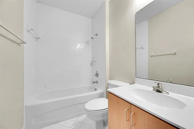 a bathroom with a sink toilet tub vanity and shower