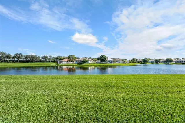 a view of a lake with houses in the back