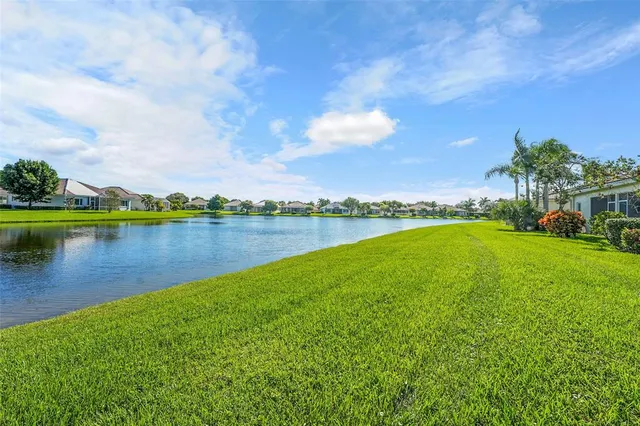 a view of a lake with houses in the back