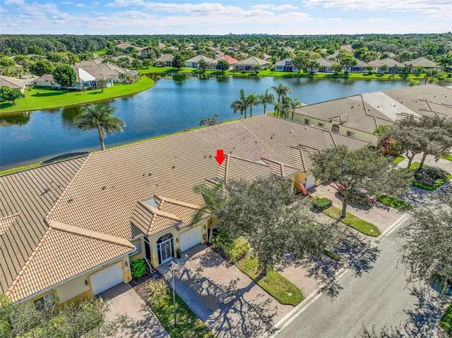 an aerial view of a house with a lake view