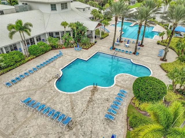 a view of a backyard with plants and outdoor seating