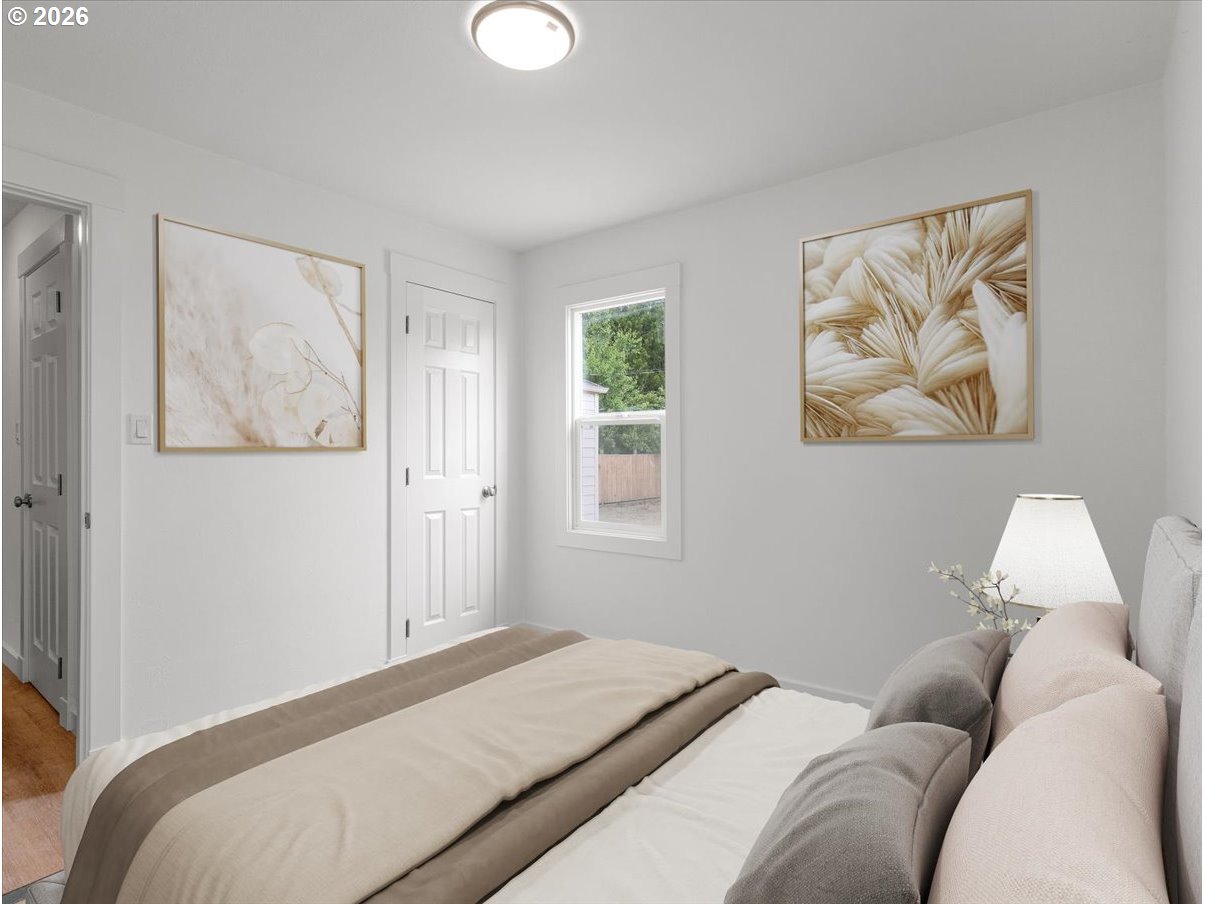 440 25th Avenue Longview, WA 98632 - Photo 10 of 27 a bedroom with a bed and a painting on the wall