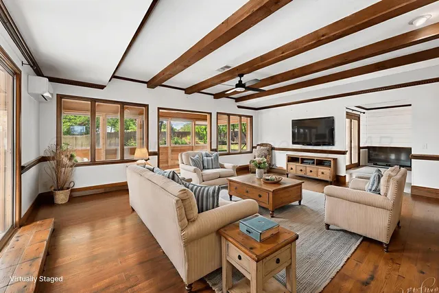 a living room with fireplace furniture and a flat screen tv