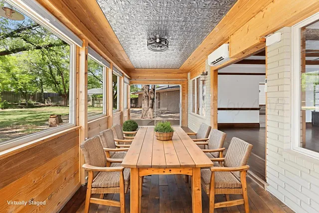 a view of a patio with table and chairs and wooden floor