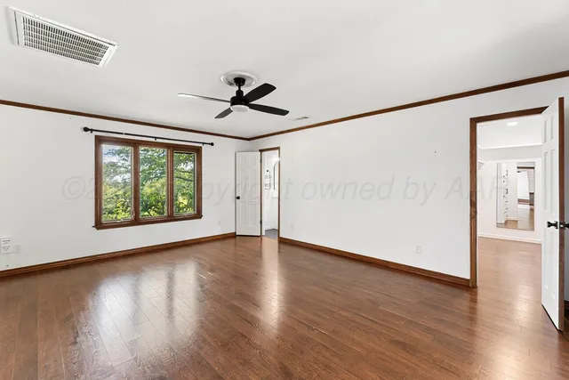 a spacious bathroom with a tub sink and mirror
