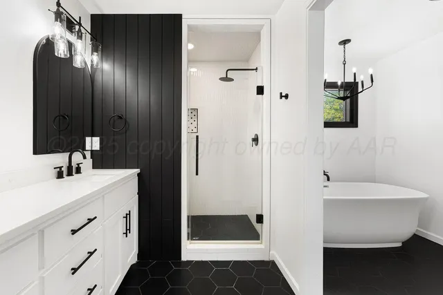 a kitchen with white cabinets and wooden floor