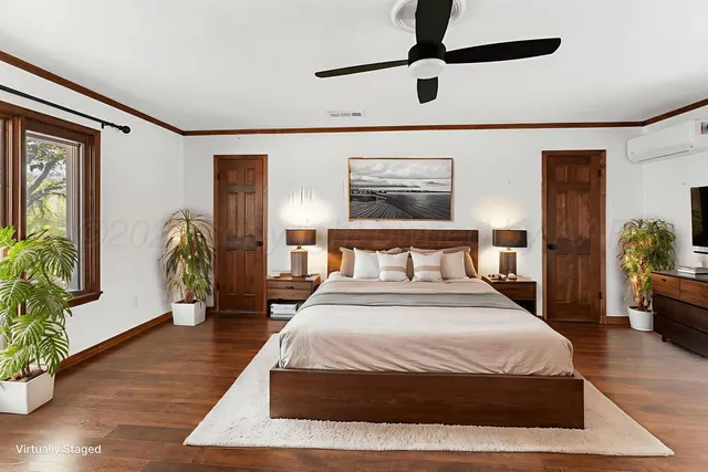 a large bedroom with wooden floor