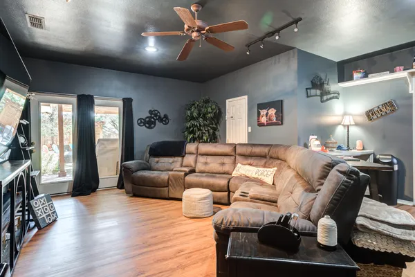 a living room with furniture and a flat screen tv