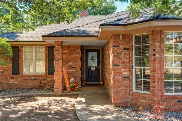 a living room with furniture and a large mirror with wooden floor
