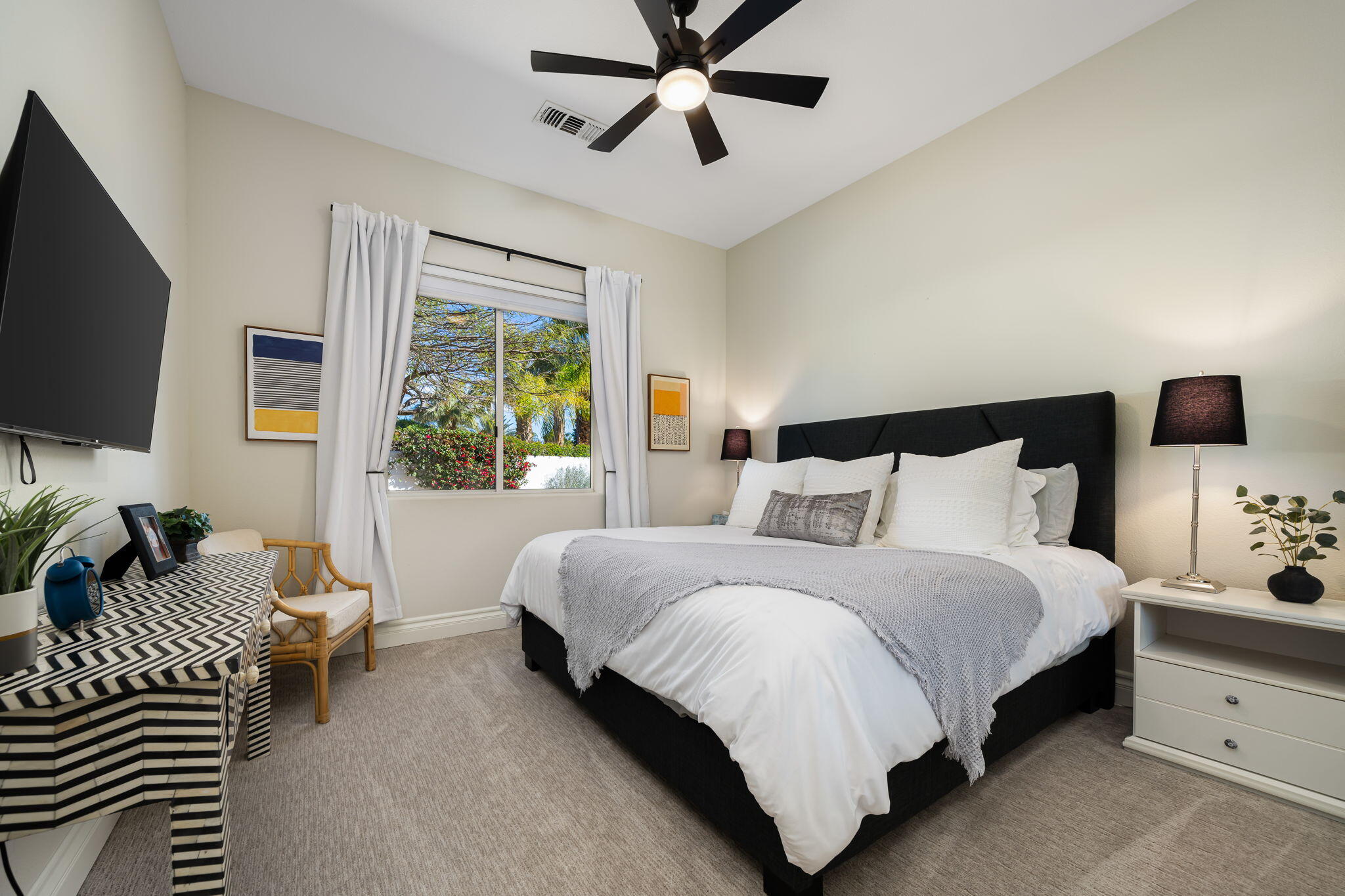 275 Loch Lomond Road Rancho Mirage, CA 92270 - Photo 17 of 29 a spacious bedroom with a bed and a flat screen tv