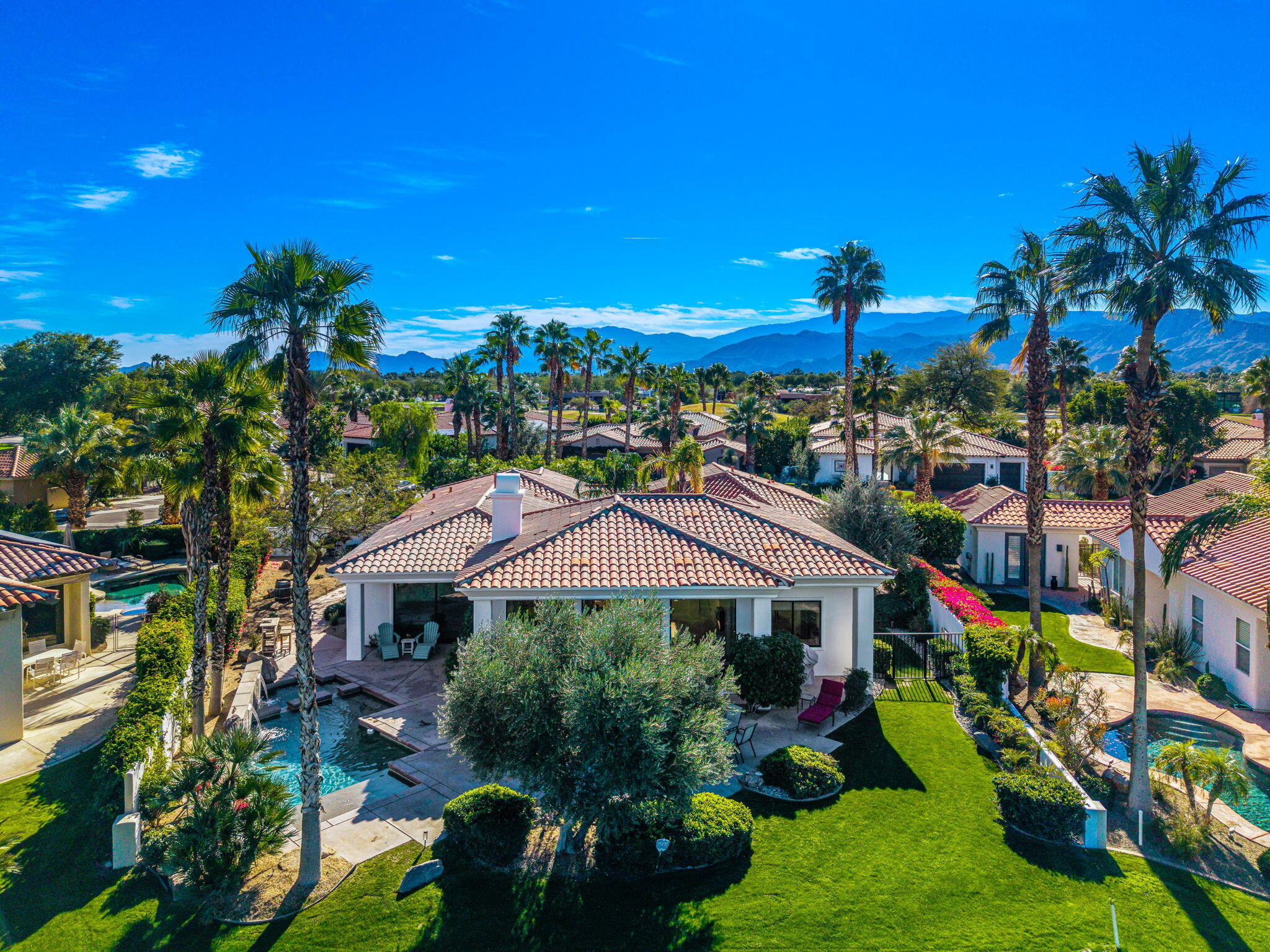 275 Loch Lomond Road Rancho Mirage, CA 92270 - Photo 27 of 29 a view of a house with a yard and potted plants