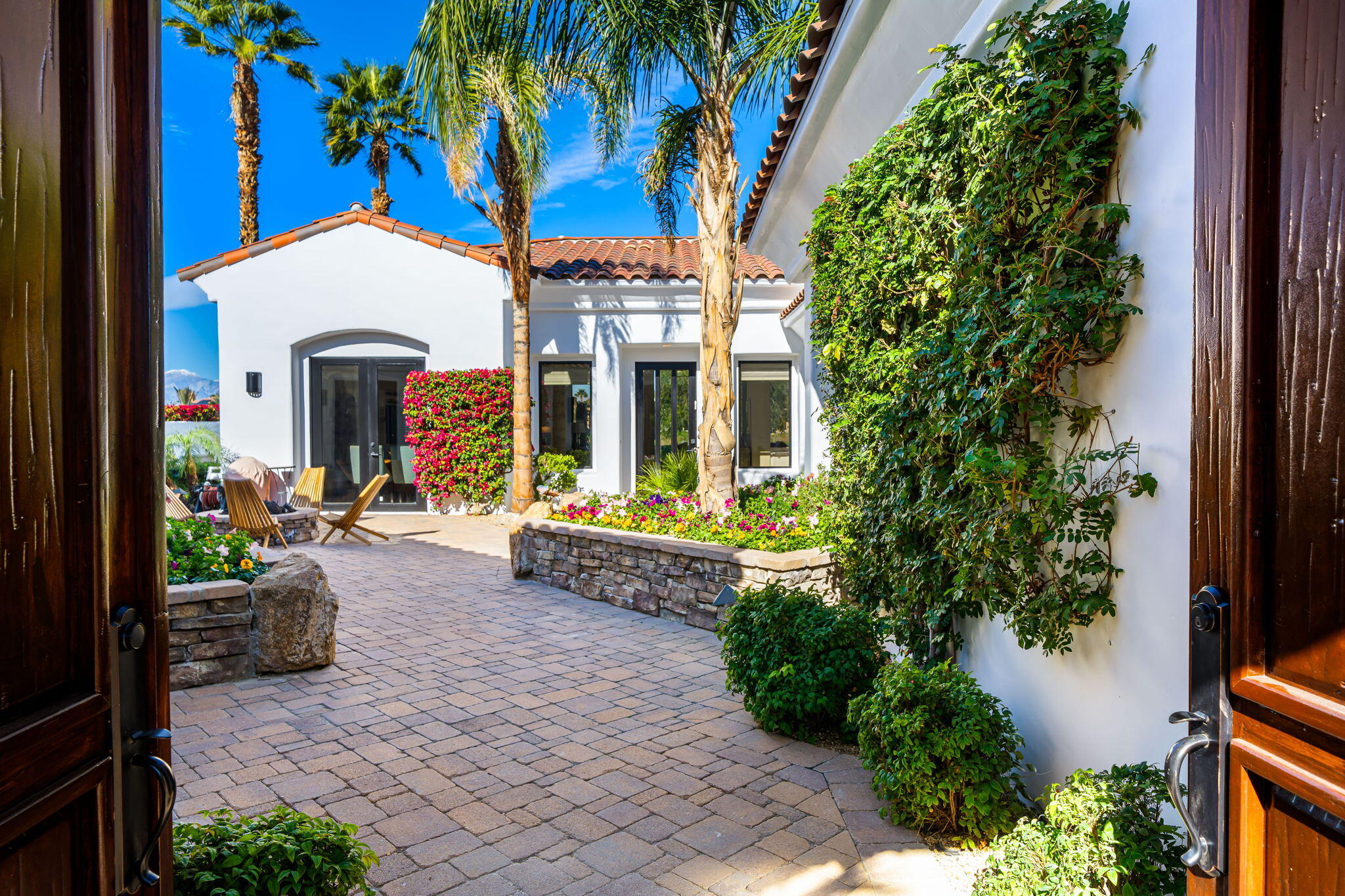 275 Loch Lomond Road Rancho Mirage, CA 92270 - Photo 3 of 29 a view of a house with fountain and a potted plant