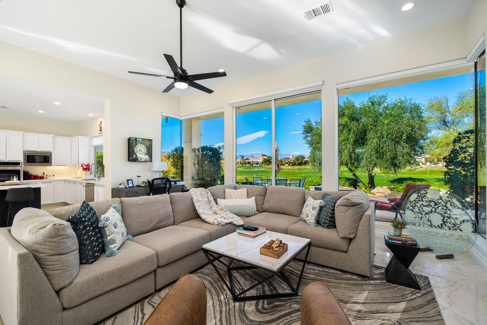 275 Loch Lomond Road Rancho Mirage, CA 92270 - Photo 9 of 29 a living room with furniture a ceiling fan and a large window