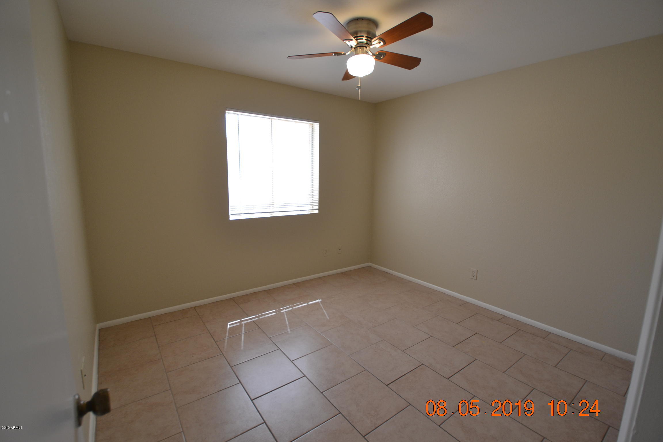 1431 West Behrend Drive Phoenix, AZ 85027 - Photo 12 of 15 an empty room with windows and fan