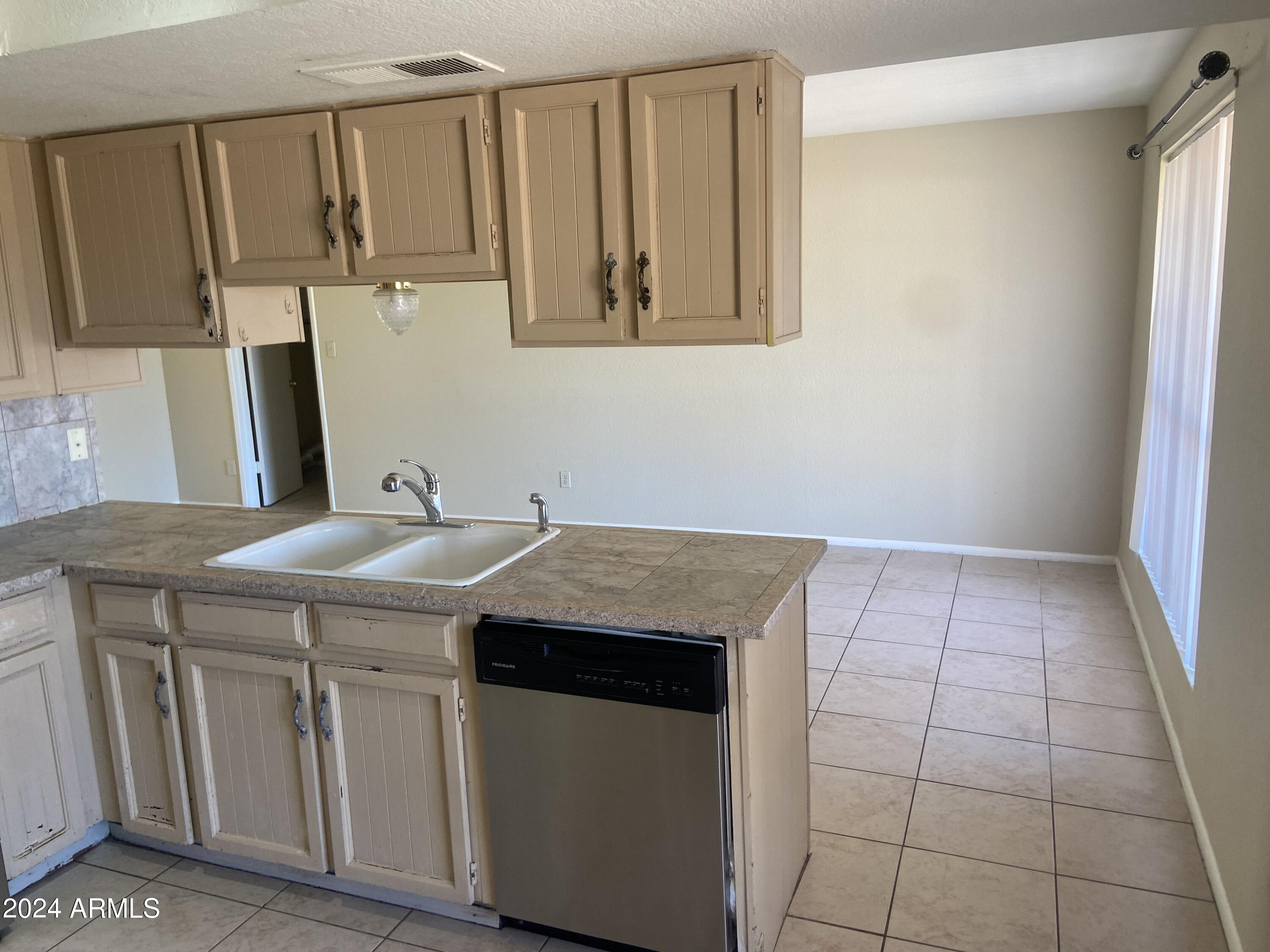 1431 West Behrend Drive Phoenix, AZ 85027 - Photo 4 of 15 a kitchen with a sink and cabinets