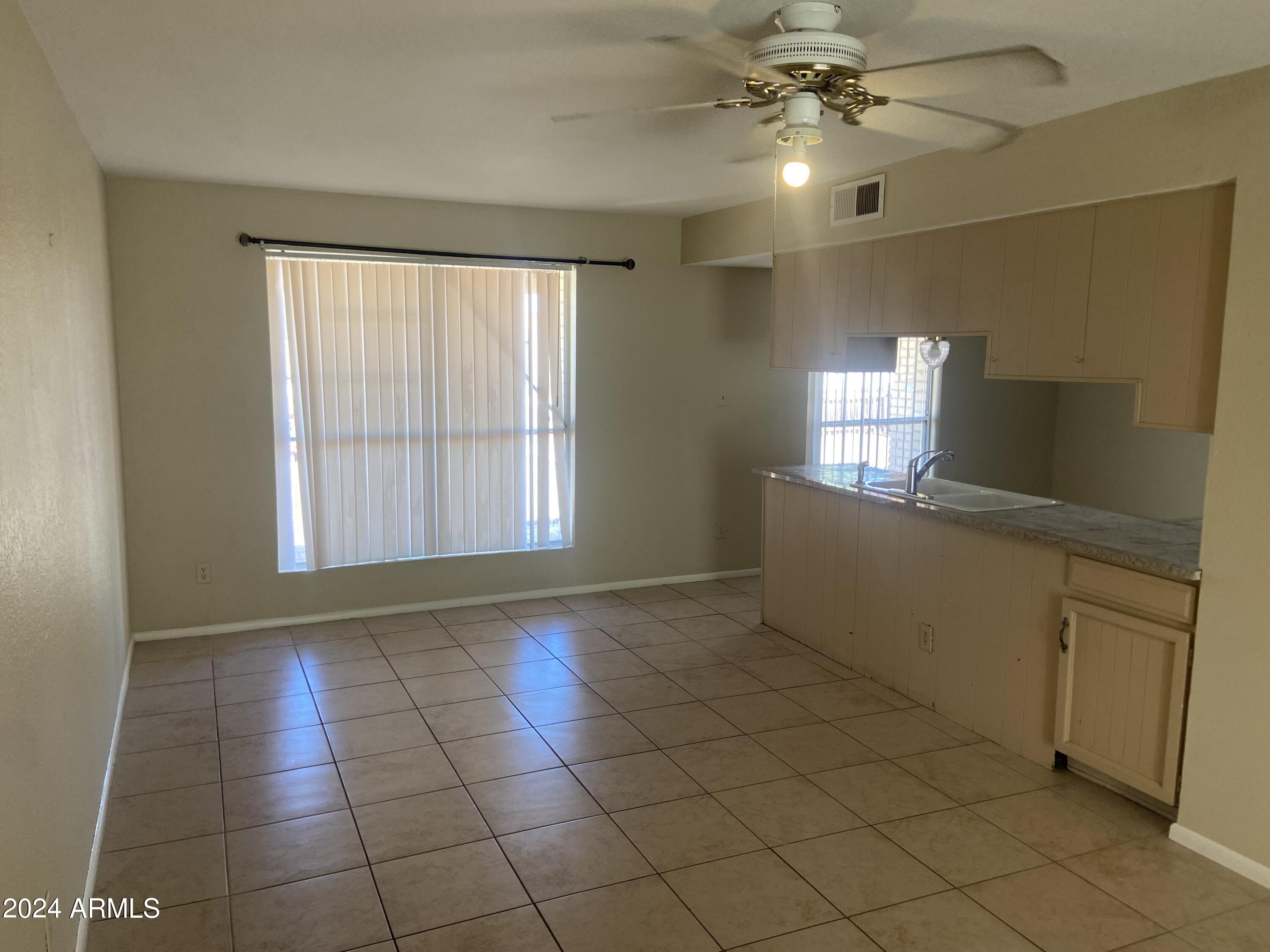 1431 West Behrend Drive Phoenix, AZ 85027 - Photo 5 of 15 a view of a kitchen with cabinet and windows