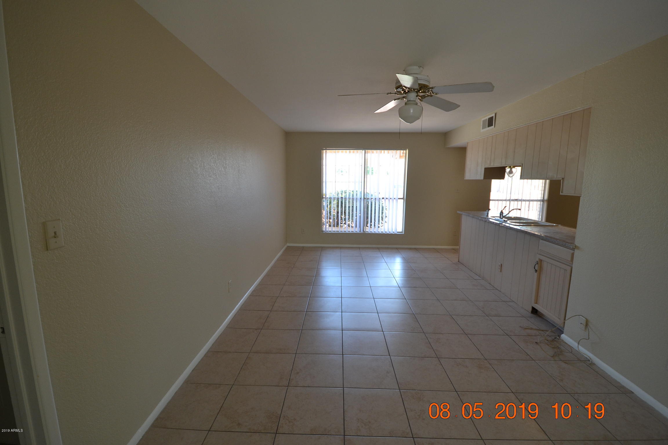 1431 West Behrend Drive Phoenix, AZ 85027 - Photo 6 of 15 a view of an empty room and window chandelier fan