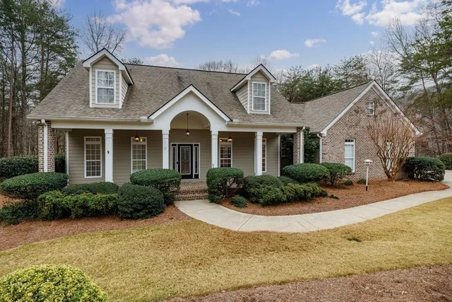a front view of a house with yard and outdoor seating