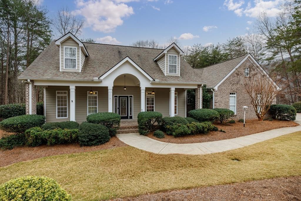a front view of a house with yard and outdoor seating