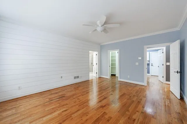 a view of an empty room and wooden floor