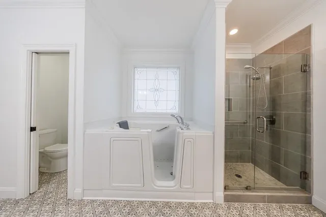 a bathroom with a shower a toilet and a sink