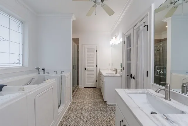a bathroom with a tub sink and mirror