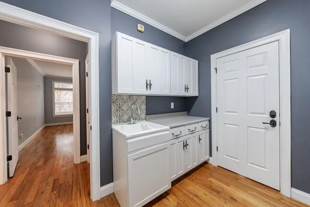a view of a kitchen with wooden floor